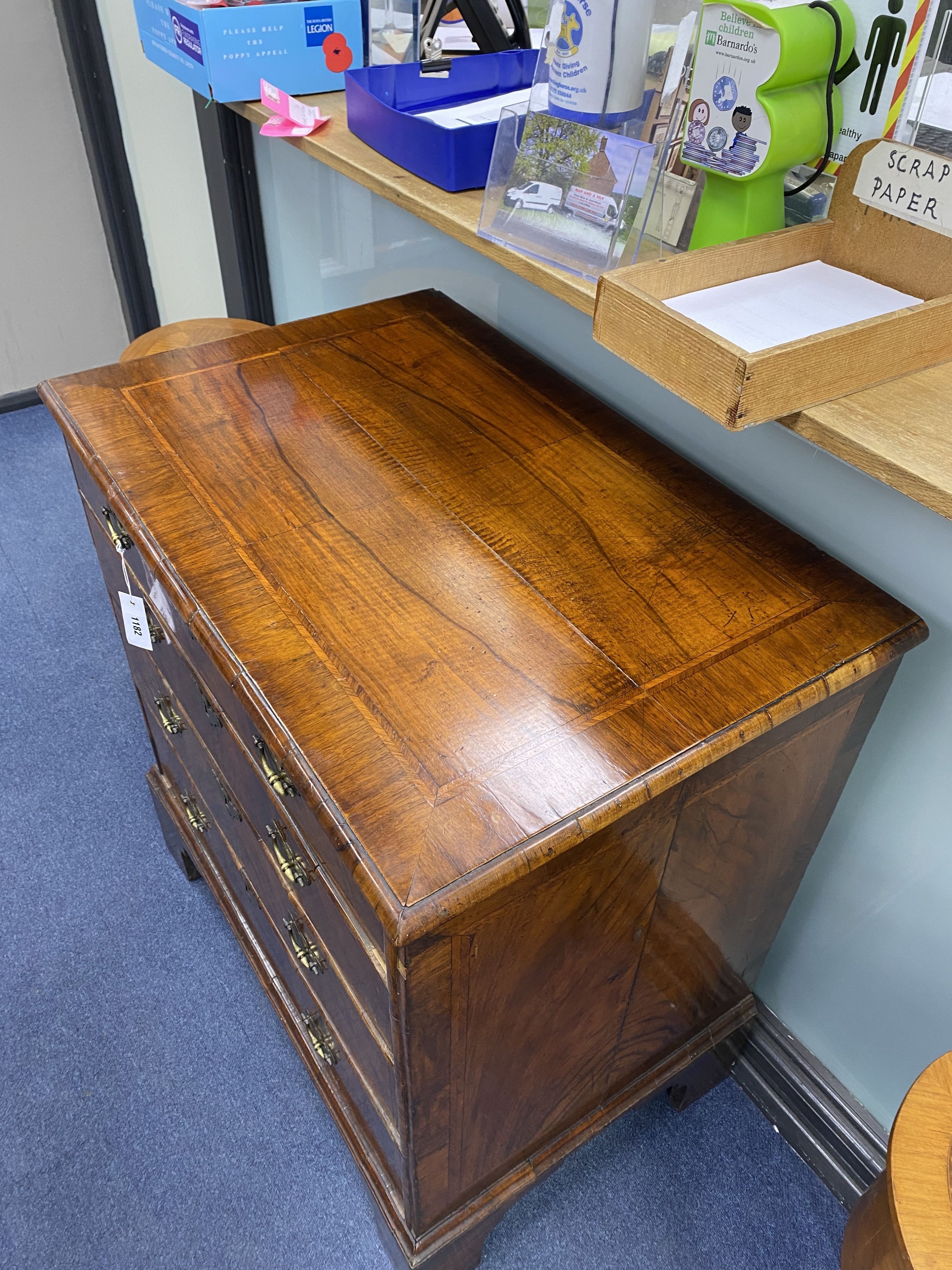 An 18th century and later walnut veneered chest of four graduating drawers raised on bracket feet, width 80cm, depth 52cm, height 88cm